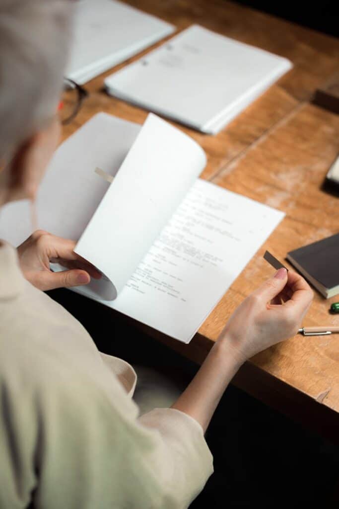 Close-up of a person reading a script, focusing on details.