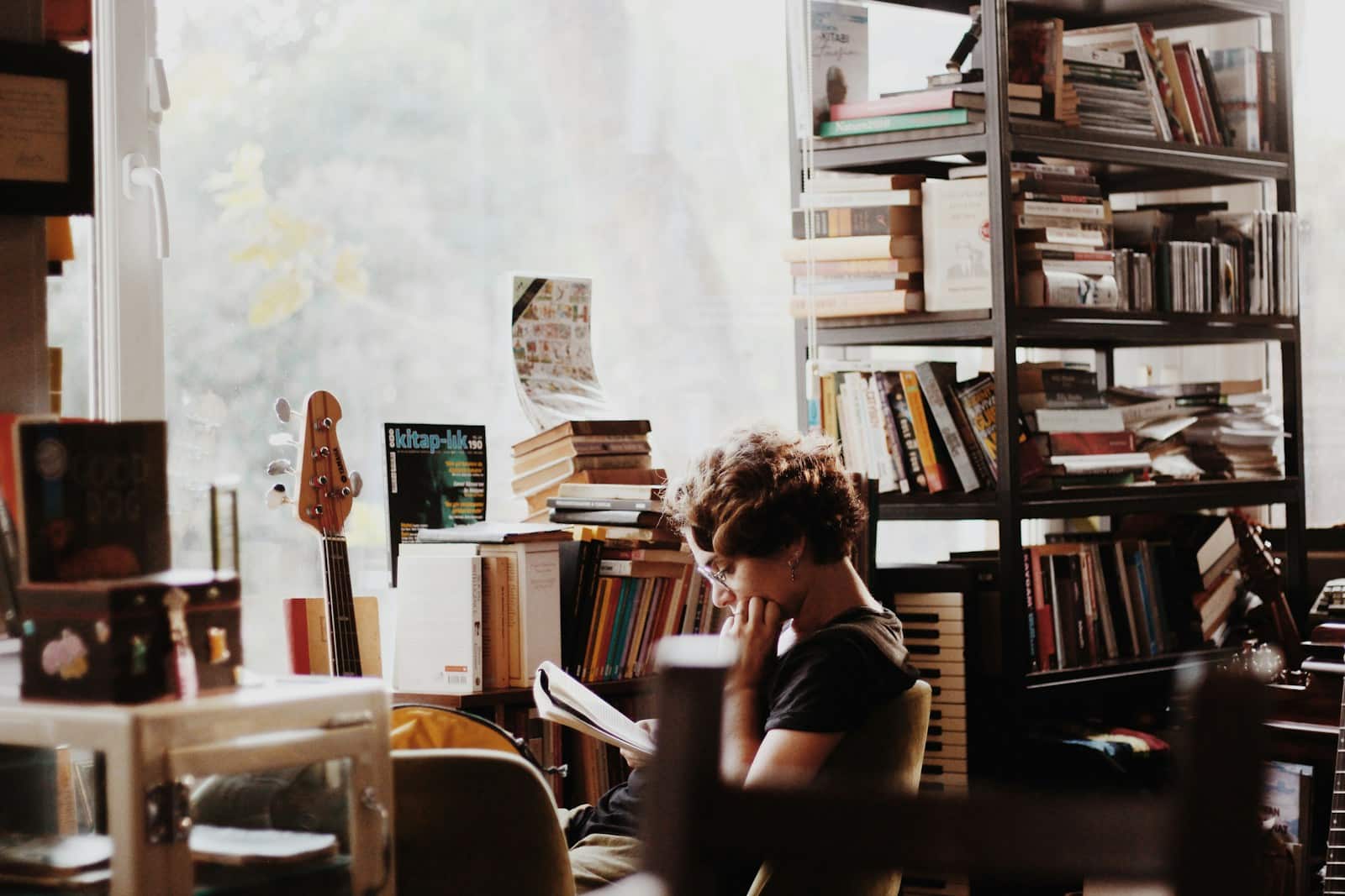 woman reading book sitting beside electronic keyboard best christian books
